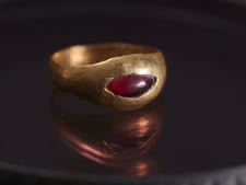 טבעת עשויה מזהב ומשובצת אבן חן אדומה [צילום: אמיל אלג'ם, רשות העתיקות]